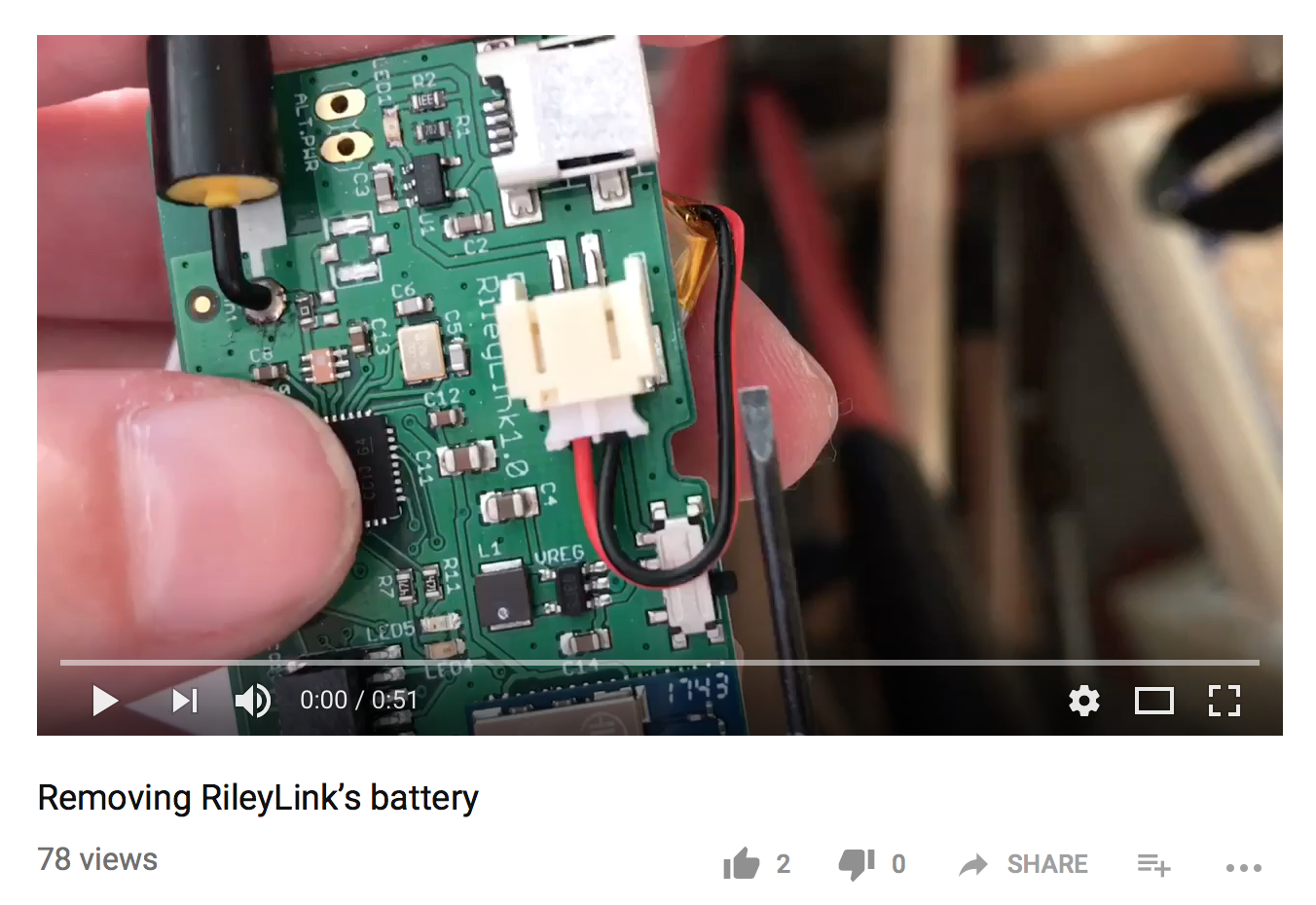 frame from video showing how to remove battery from RileyLink, follow link for video